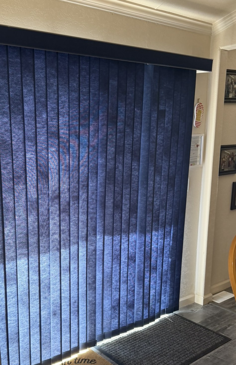 Dated blue vertical blinds on a sliding patio door before replacement