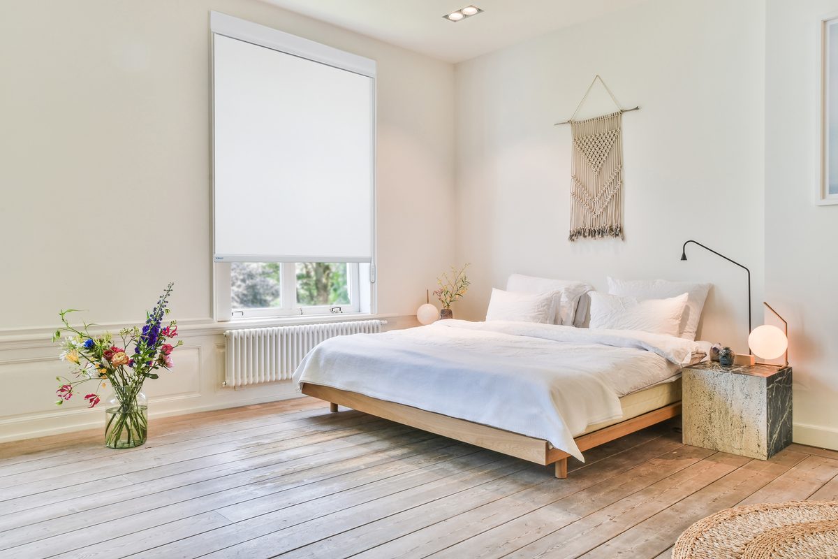 Motorized roller shade in a light bedroom