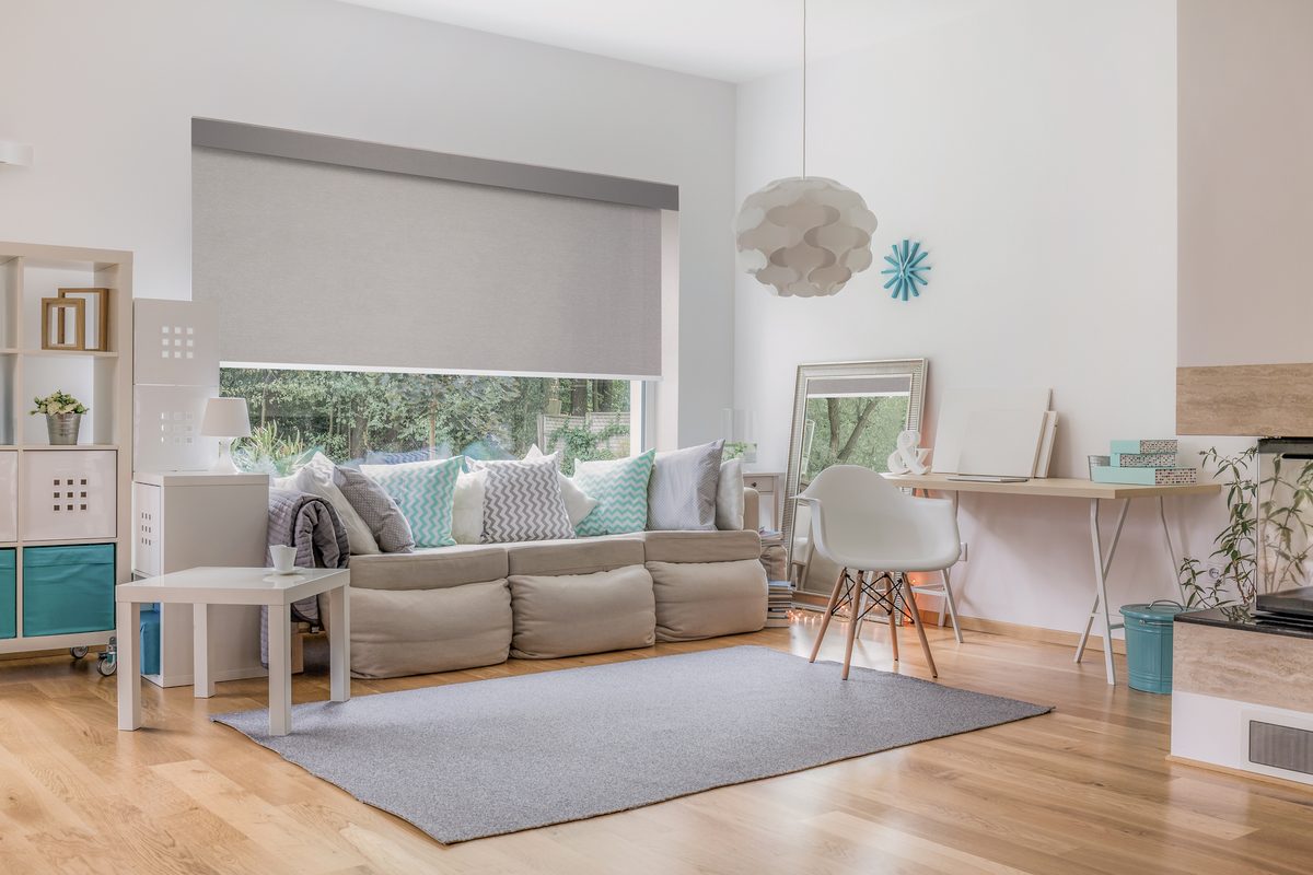 Roller shades in a bright open living room