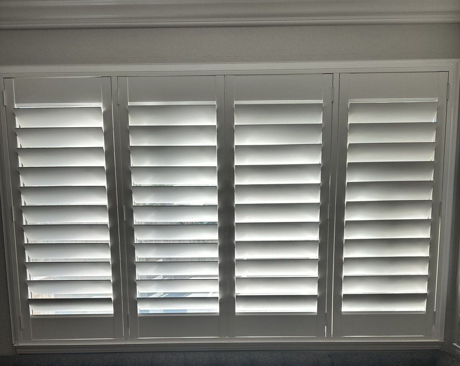 Custom white plantation shutters installed in a Santa Clarita dining nook